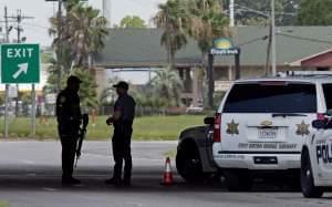 Baton Rouge Police with assault rifles block Airline Highway after police were shot in Baton Rouge, La., Sunday, July 17.