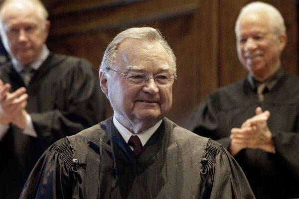 Justice Lloyd Karmeier is congratulated by fellow Illinois Supreme Court Justices after being sworn in as the chief justice of the Illinois Supreme Court Monday, Oct. 31, 2016, in Springfield