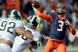 Illinois quarterback Jeff George Jr. passes against the defense of Michigan State linebacker Riley Bullough  and defensive tackle Kevin Williams  during the second half of an NCAA college football game at Memorial Stadium on Saturday. 