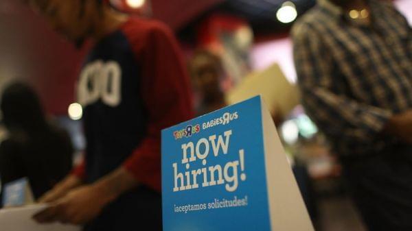 A now hiring sign at a job fair in Florida.