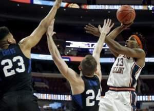 Illinois guard Tracy Abrams, right, shoots against BYU forward Yoeli Childs, left, and guard Davin Guinn during the first half of an NCAA college basketball game Saturday, Dec. 17, 2016, in Chicago. 