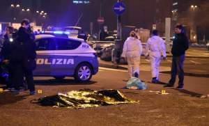 A body is covered with a thermic blanket after a shootout between police and a man near a train station in Milan's Sesto San Giovanni neighborhood, 