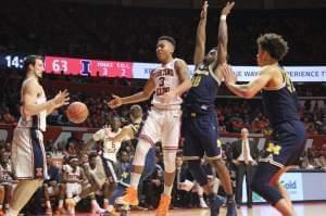 Illini Te'Jon Lucas (3) dumps a no-look assist to Maverick Morgan (22) in Wednesday's 85-69 win over Michigan, in Champaign.