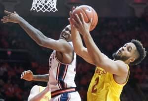 Illinois' forward Leron Black tries to bat away a rebound by Maryland's guard Melo Trimble.