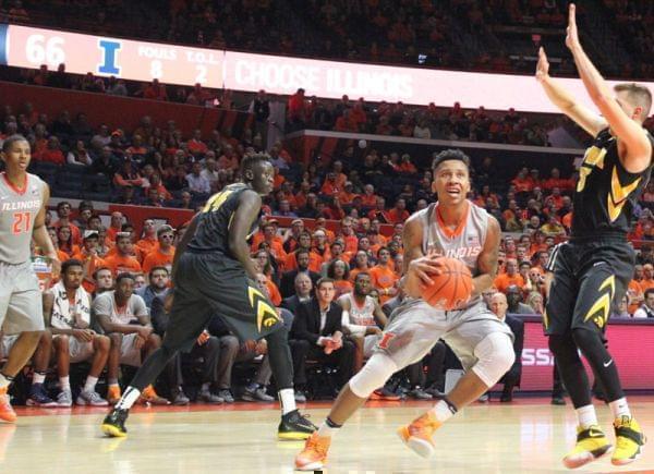 Illini Te'Jon Lucas drives to the basket as teammate Malcolm Hill (21) looks on.