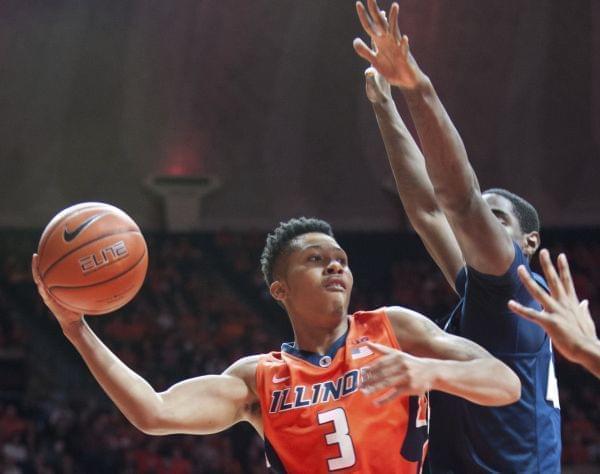 Illinois' guard Te'Jon Lucas (3) looks to pass under the basket as Penn State's forward Mike Watkins (24) defends during an NCAA college basketball game in Champaign.