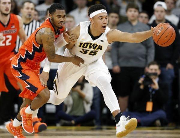 Illinois guard Jaylon Tate, left, fights for a loose ball with Iowa forward Cordell Pemsl during the second half of Saturday's Illini win in Iowa City, Iowa. 