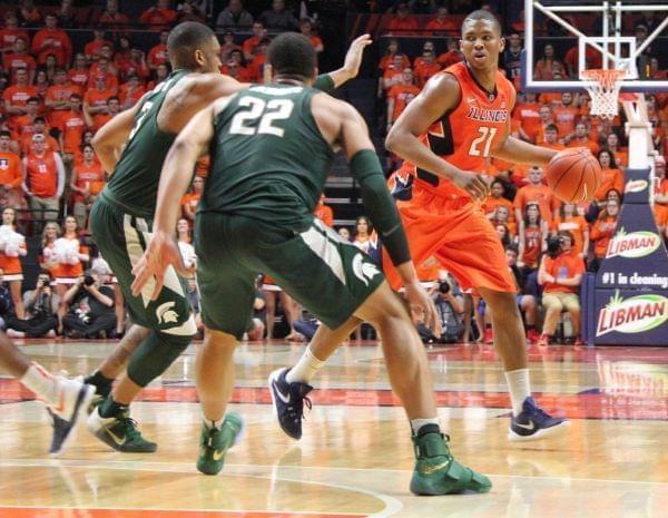Illini Malcolm Hill dribbles past a double team of Alvin Ellis III & Miles Bridges (22)