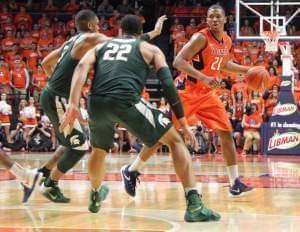 Illini Malcolm Hill dribbles past a double team of Alvin Ellis III & Miles Bridges (22)