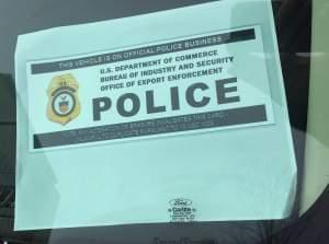 An official parking placard visible inside the windshield of a car parked in front of Caterpillar headquarters on Adams Street in downtown Peoria today