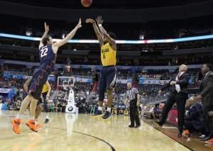 Derrick Walton shooting over Maverick Morgan in a Big Ten tournament basketball game.