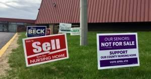 Signs promoting the two referenda regarding the Champaign County Nursing Home.