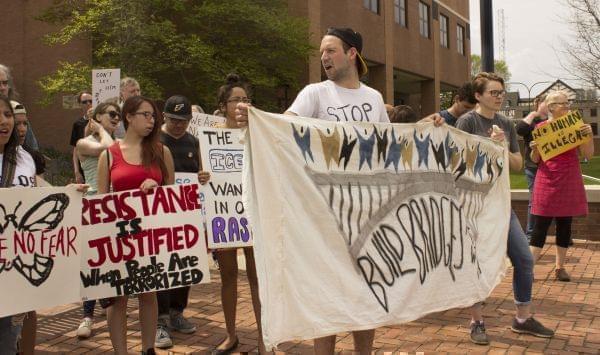 Members of the CU Immigration Forum rally outside the federal courthouse in Urbana Friday.