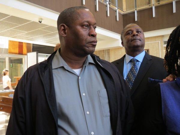 Cleve Heidelberg's son, Steve, looks on as attorney Andy Hale speaks to reporters after Friday's bond hearing. Steve Heidelberg, 54, lives in Springfield. 