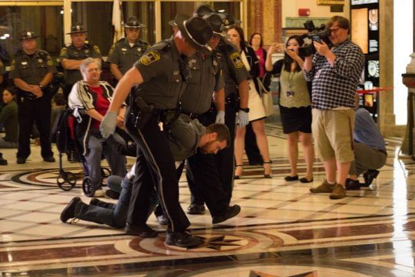 Nearly three-dozen activists were arrested during a sit-in Tuesday night at the Illinois State Capitol.
