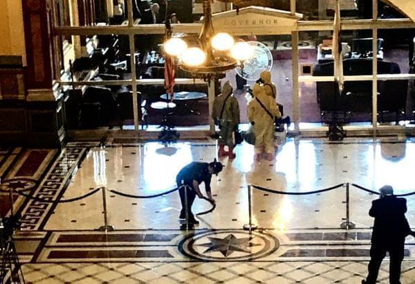 Hazmat crew enters the governor's office at the Illinois Statehouse Thursday.
.