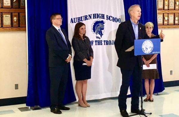 Gov. Bruce Rauner, flanked by Auburn Supt Darren Root, and St. Representatives Avery Bourne, Sara Wojcicki Jimenez.