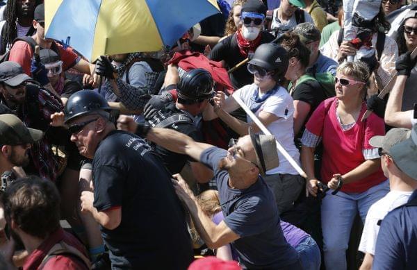 White nationalist demonstrators clash with counter demonstrators at the entrance to Lee Park in Charlottesville, Va., Saturday, Aug. 12. 