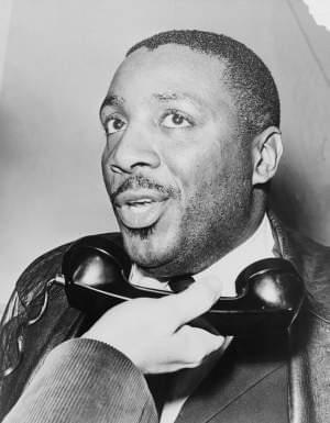 Dick Gregory holding a telephone