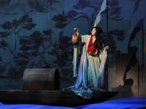 actor in boat on stage