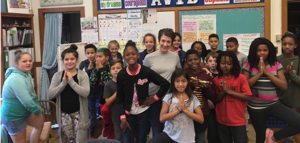 instructor Ashley Krstulovich surrounded by a 5th grade glass at Butler Elementary School.