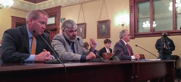 Democratic Rep. Marty Moylan, right, listens to NRA lobbyist Todd Vandermyde, second from left, testify against legislation to ban bump stocks and other trigger modifications at a House Judiciary Criminal Law Committee hearing on Tuesday, Oct. 24, 20