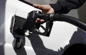 A person pumps gas into their car.