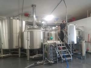 An employee tends to brewing equipment at the Riggs Brewing Company in Urbana.