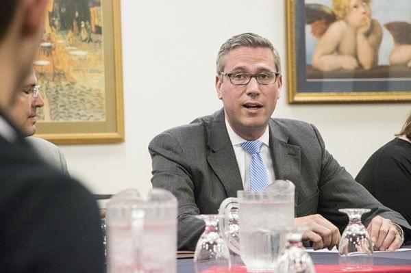 Michael Frerichs speaking at a table.