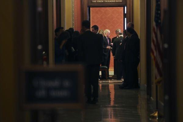 Senate Majority Leader Mitch McConnell of Ky., center, and Sen. Roy Blunt, R-Mo., at the end of a close-door meeting with fellow Republican senators, Monday, Jan. 22, 2018, on Capitol Hill in Washington on day three of the government shutdown.