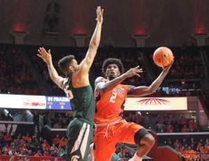 Illini Kipper Nichols (2) converts a left-handed hook shot despite the defensive pressure of Michigan State's Kenny Goins