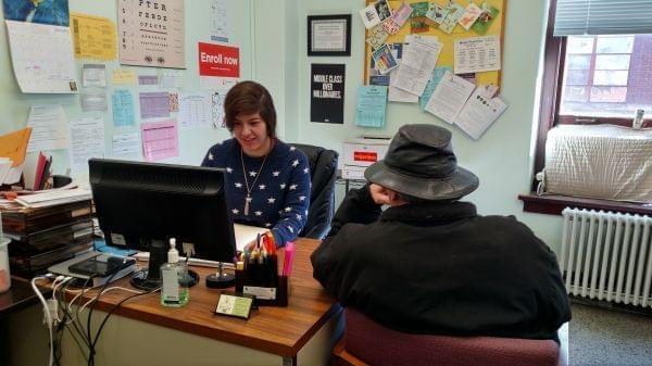 Adani Sanchez, client services coordinator for Champaign County Health Care Consumers, meets with a client in her office on January 2, 2018.