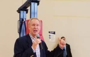 Gov. Bruce Rauner talks to employees at the Litania Sports Group athletic equipment company in Champaign.