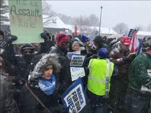 People marching at Douglass Park in Champaign to advocate for stronger gun control laws.