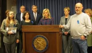 Rep. Tony McCombie (R, Savanna) flanked by family members of slain DCFS worker Pam Knight. McCombie called for a rehearing of a workplace violence bill named after Knight at a news conference on April 17.