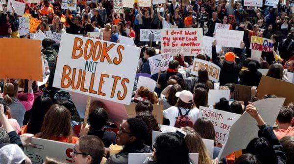 A large crowd of students holding signs