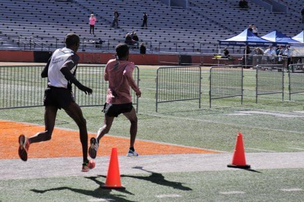 Wilson Chemweno (left) and Tesfaalem Mehari enter Memorial Stadium for the finish of the Christie Clinic Illinois Marathon. The two would tie for first with a time of 2:21:03.