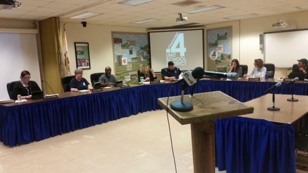 Champaign Unit 4 School Board members seated in their meeting room