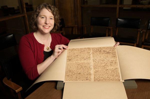 Lynne Thomas poses with Isaac Newton manuscript.
