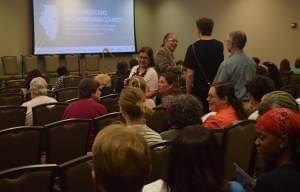 Community members gather as the University YMCA's New American Welcome Center and other partner organizations present a report documenting contributions of immigrants in Champaign County.