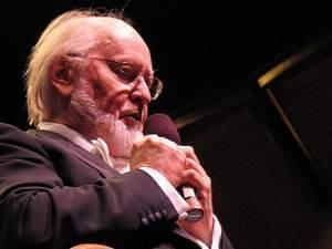 John Williams speaks on a microphone