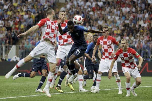 Croatia's Ivan Perisic, second left, handles the ball to give away a penalty as he jumps for the ball with France's Blaise Matuidi during the final match between France and Croatia.