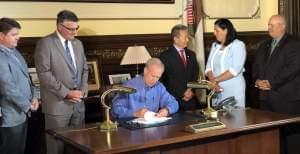 Gov. Bruce Rauner signing legislation. 