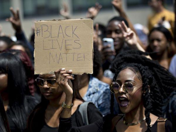 A demonstrator holds a "Black Lives Matter" sign while protesting then-presidential candidate Donald Trump in 2016. The hashtag started five years ago and is an "archetypal" example of a hashtag tied to political issues or causes.
