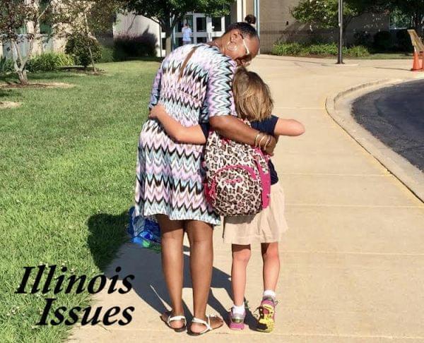 Yolanda Harrington walks one of her students into Barkstall Elementary in Champaign.