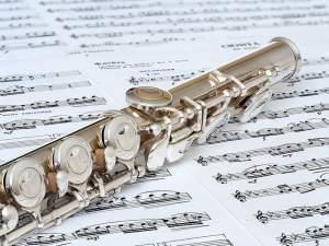 Flute on top of sheets of music.