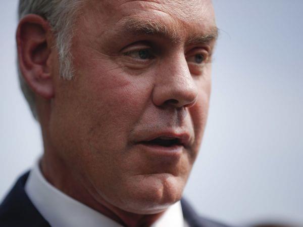 Interior Secretary Ryan Zinke speaks to members of the media outside the White House in August.