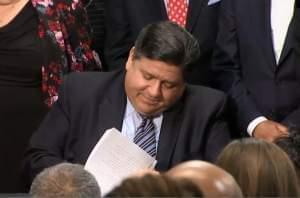 Gov. JB Pritzker signs gun dealer licensing measures at a ceremony in Chicago on Jan. 17.