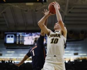 Illinois guard Trent Frazier, left, tries to defend against a shot by Iowa guard Joe Wieskamp, right, during the second half of an NCAA college basketball game, Sunday, Jan. 20, 2019, in Iowa City. 