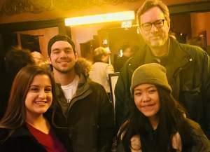 Four students smiling while posing for a group photo